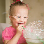 Girl,With,Down,Syndrome,Makes,Breathing,Speech,Therapy,Exercise